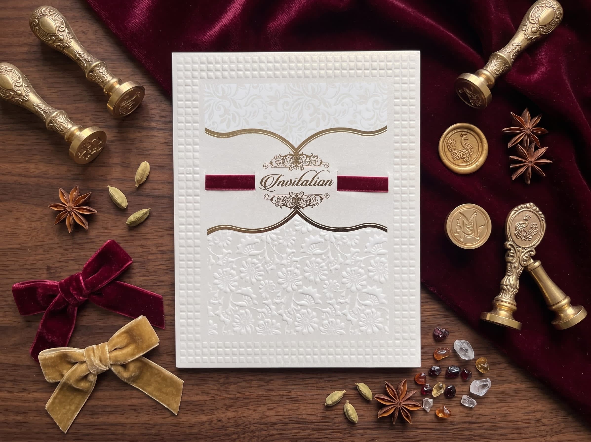 Valima reception card set with an embossed grid cover, maroon velvet Invitation band and a gold-foil insert by Shahi Bulawa Karachi